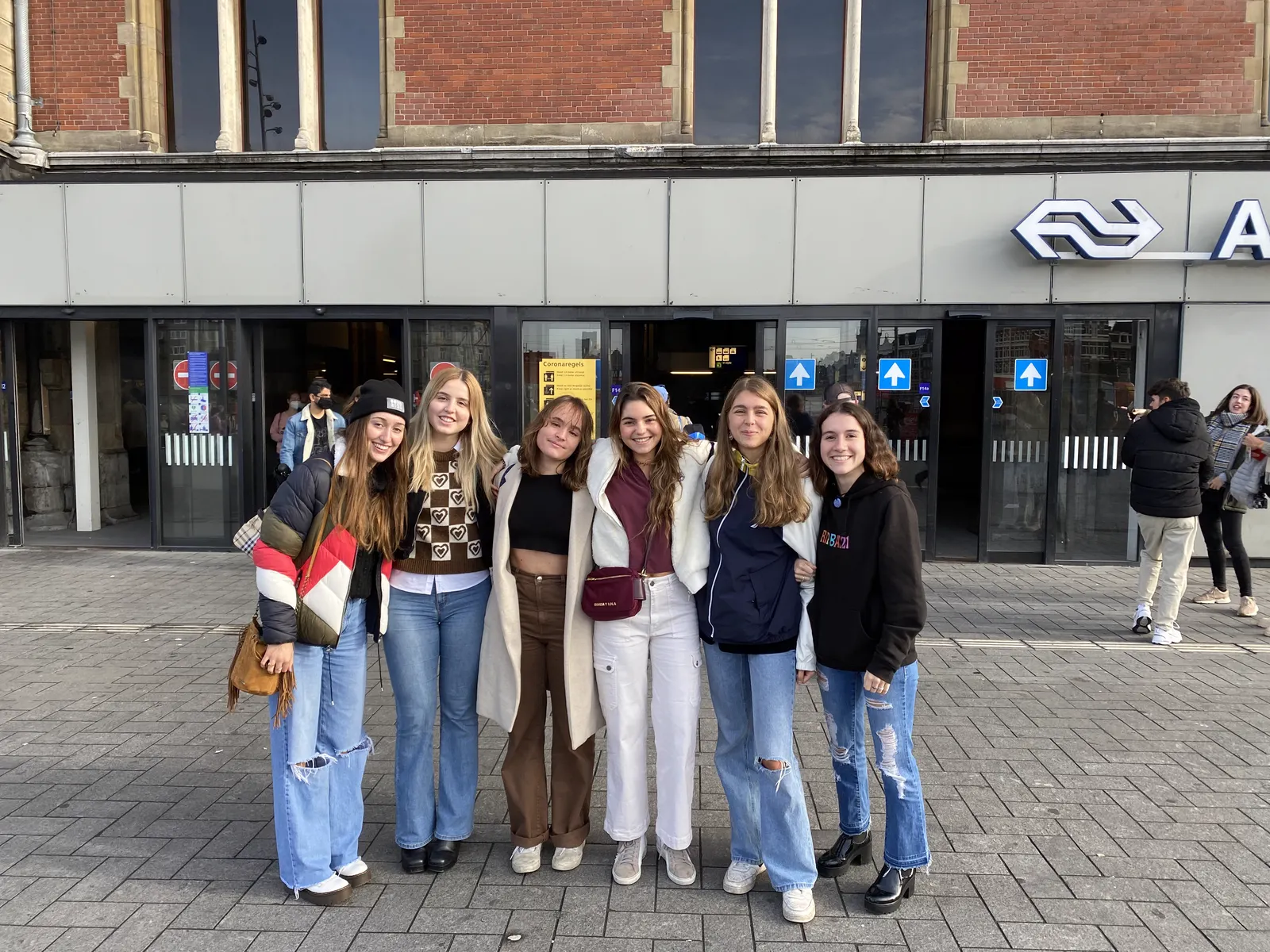 Raquel with five friends outside a Dutch railway station